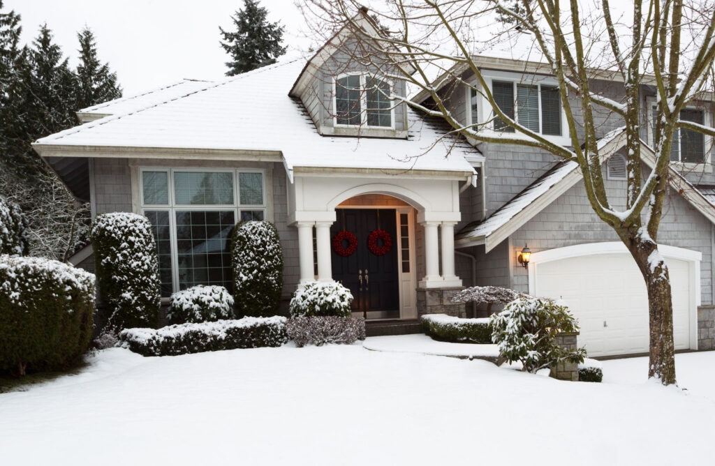 A snow-covered home prepared for winter after professional winterizing plumbing in Wenatchee, WA.