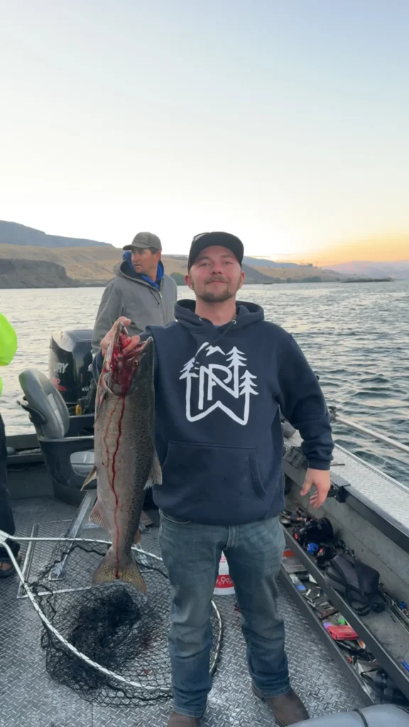 Kole holding a bright sockeye caught during Columbia River fishing