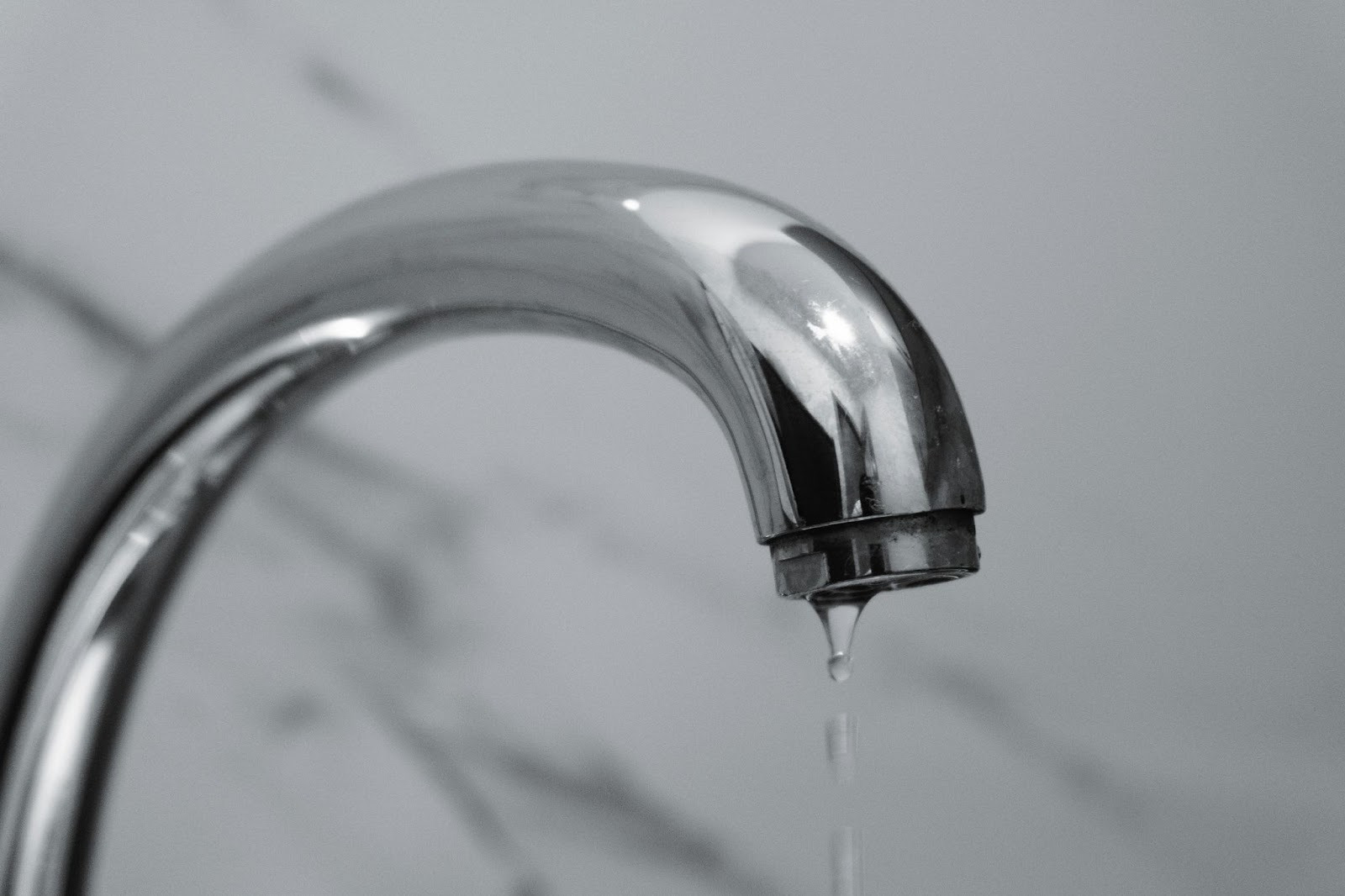 Dripping bathroom faucet showing early sign of plumbing leak