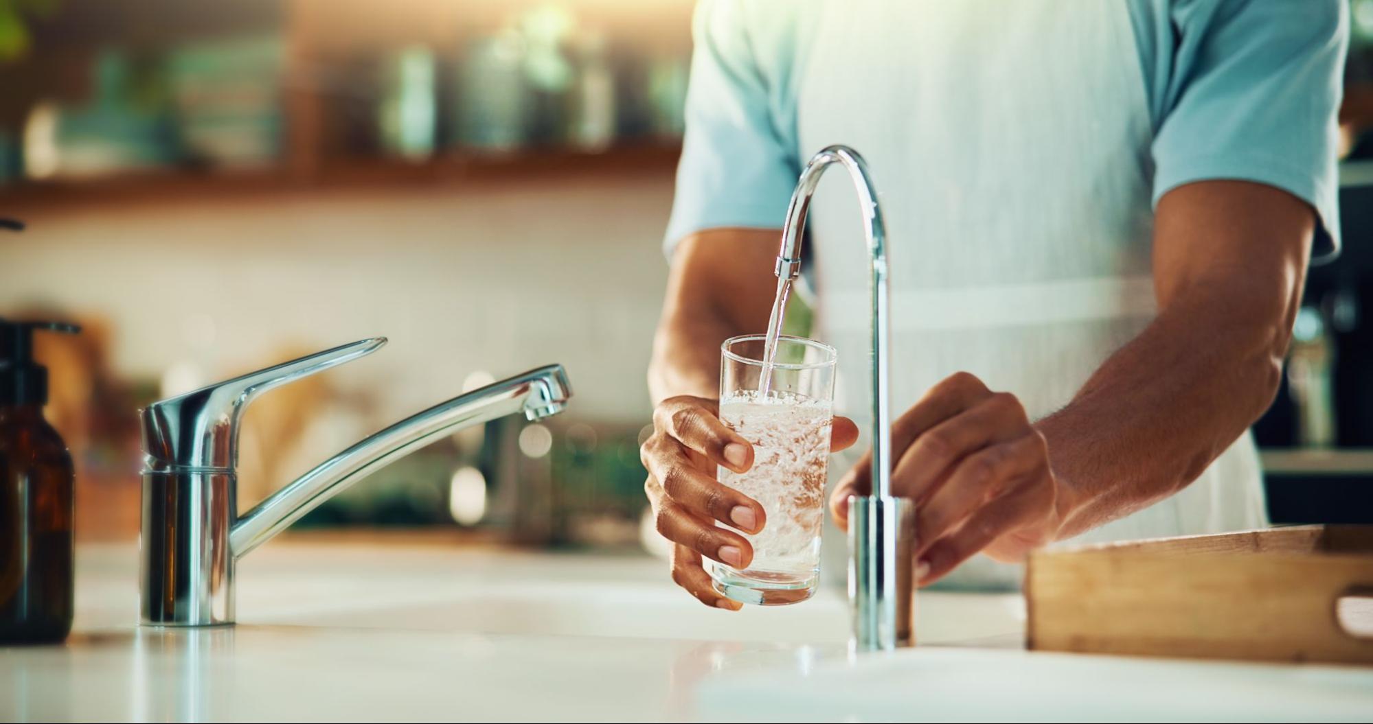 Scottsdale, AZ homeowner enjoying clean filtered water from a professionally installed water filtration system