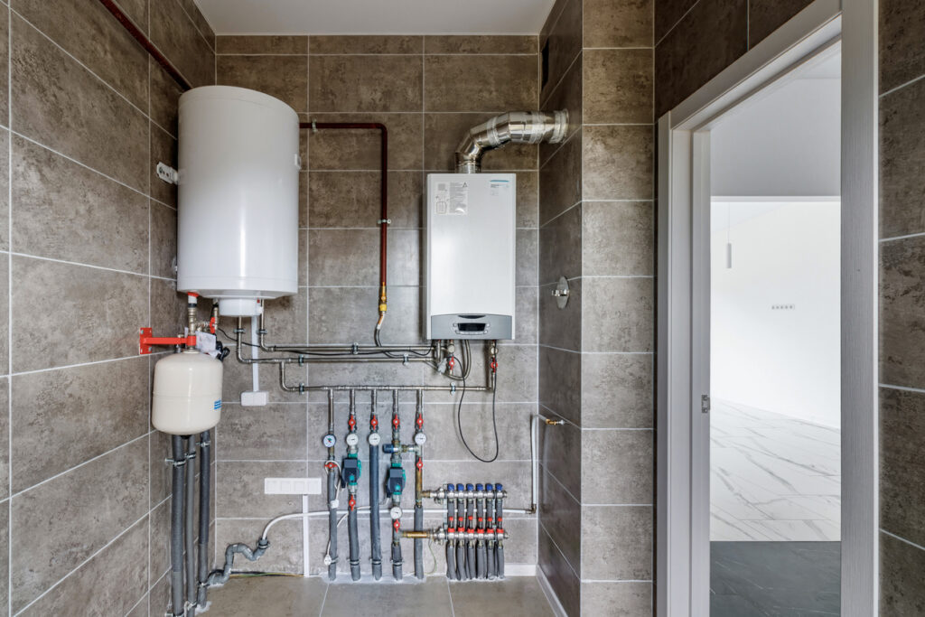 A home plumbing system with a water heater, tankless unit, and supply line manifold.