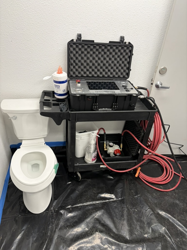 A&N Plumbing drain camera equipment set up beside a toilet with the floor covered, ready for a sewer line inspection in a Cashmere, WA home.